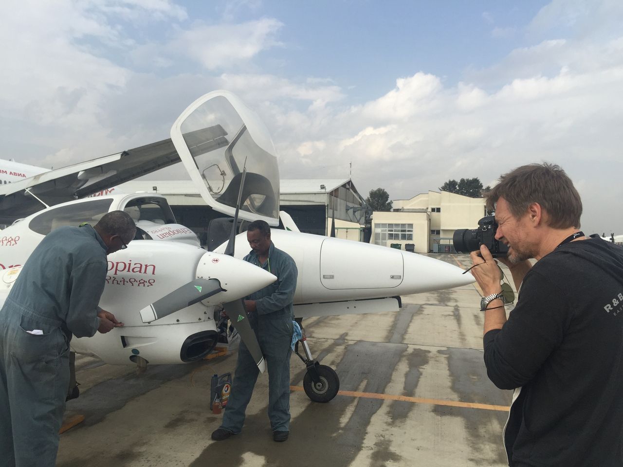 Photographer shooting an Ethiopian Airlines aircraft on the tarmac for Bombardier magazine