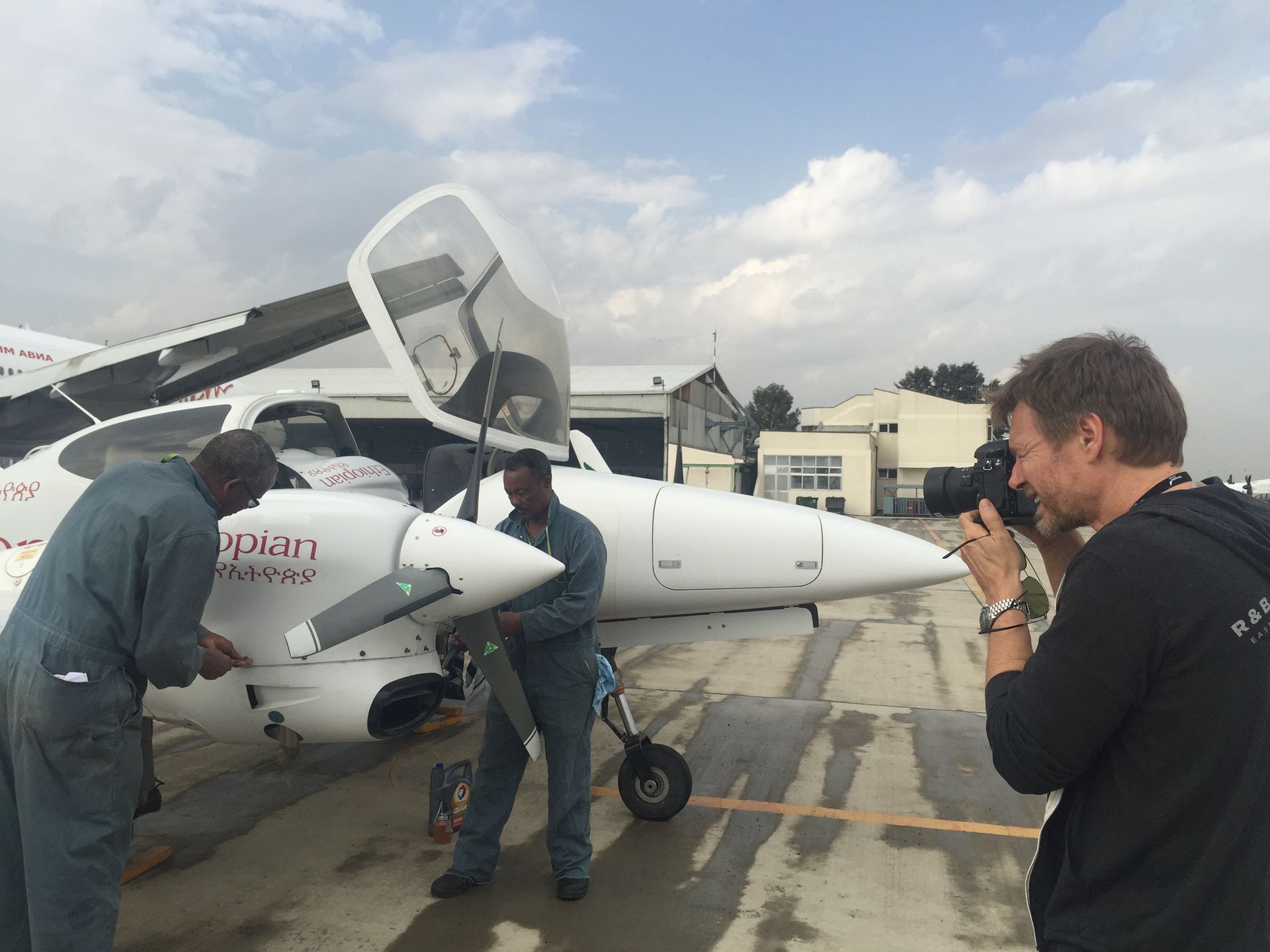 Photographer shooting an Ethiopian Airlines aircraft on the tarmac for Bombardier magazine