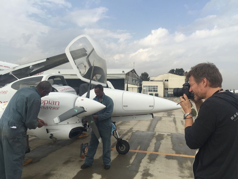 Photographer shooting an Ethiopian Airlines aircraft on the tarmac for Bombardier magazine