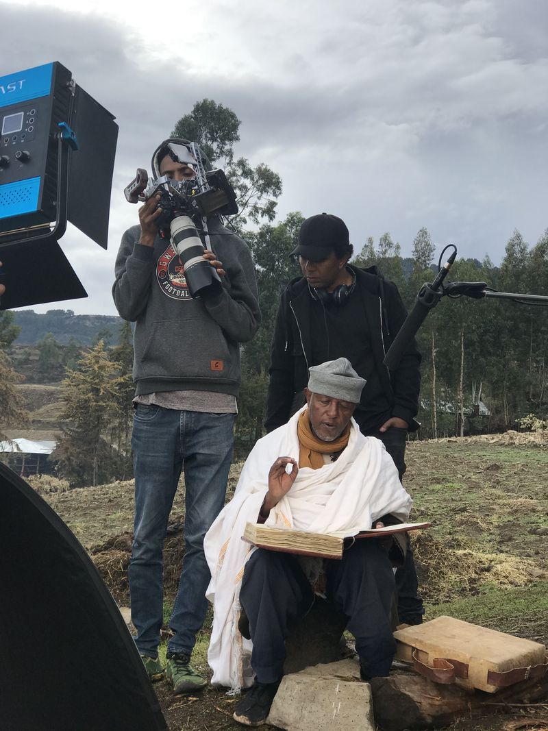 Camera crew films an Ethiopian scribe hand-lettering parchment for the Al Jazeera documentary The Bookmaker