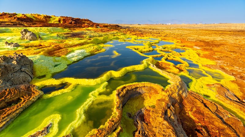 Acid-yellow sulphur and potash terraces around turquoise brine pools at Dallol in the Danakil Depression, Afar