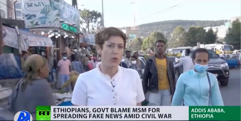 RT television correspondent reporting to camera in a crowded Addis Ababa street during news coverage in Ethiopia