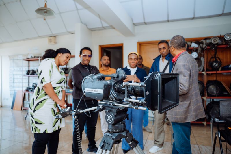 Ethiopian crew training on a cinema camera during an international filmmaking workshop in Addis Ababa
